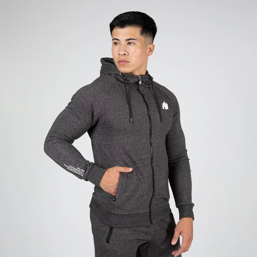 Gorilla Wear Payette Zipped Hoodie grey, en mörkgrå träningshoodie i slim fit med dragkedja buren av en man., bild 4 av 8
