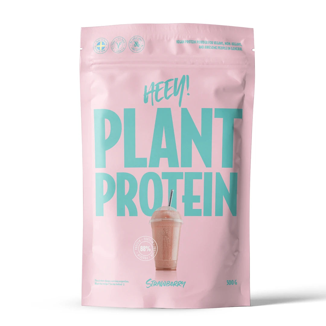 Heey! Veganskt Protein 500 g proteinpulver i en ljusrosa påse med turkos text för smaken Jordgubb., bild 2 av 9