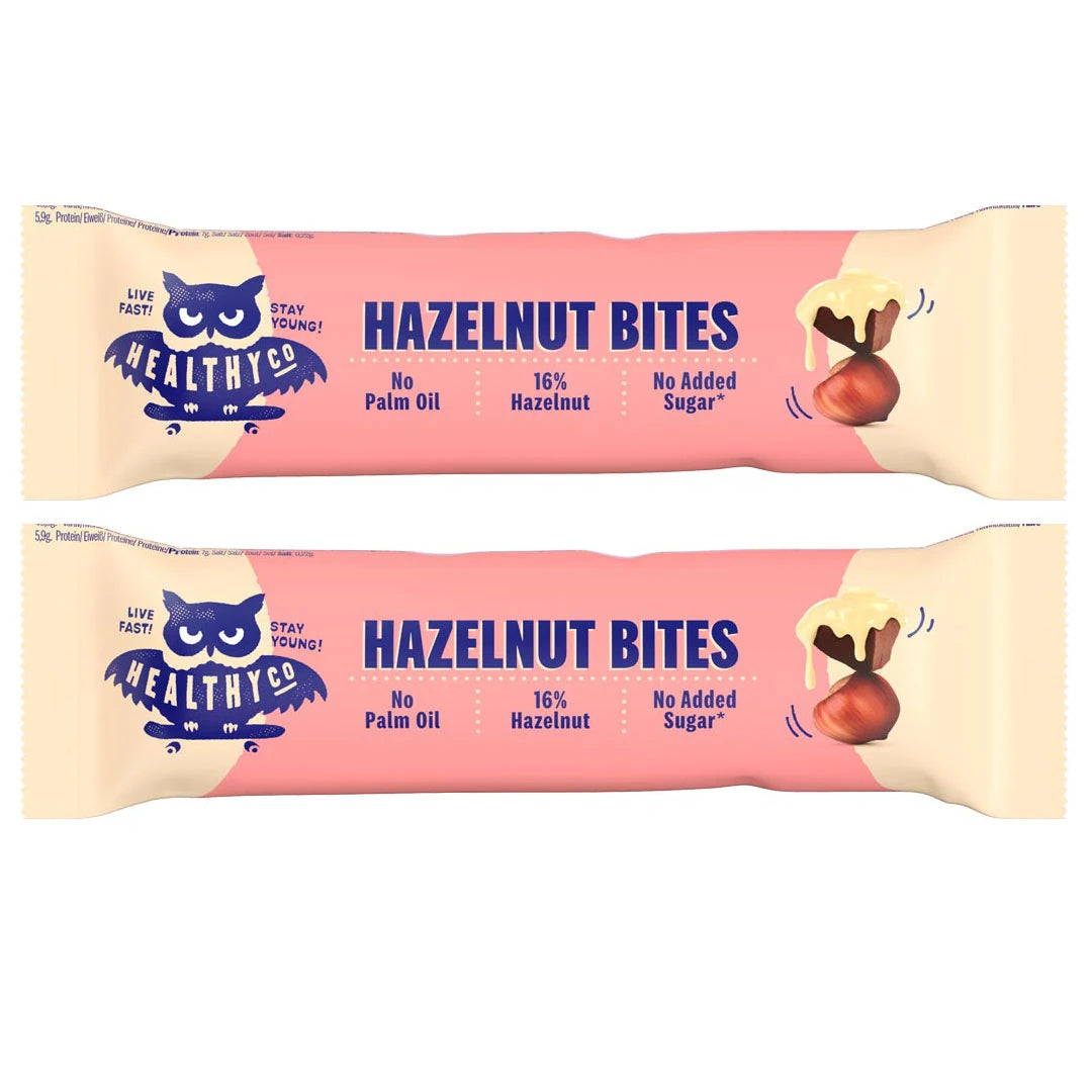 Healthyco Hazelnut Bites 21 g x 2 st i två rosa förpackningar med mörkblå text och en illustrerad hasselnöt., bild 1 av 1