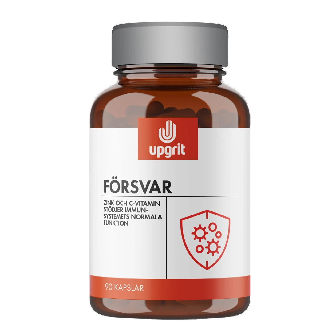 Upgrit Försvar 90 caps kosttillskott i en mörk glasburk med vit etikett och silvrigt lock., bild 1 av 1