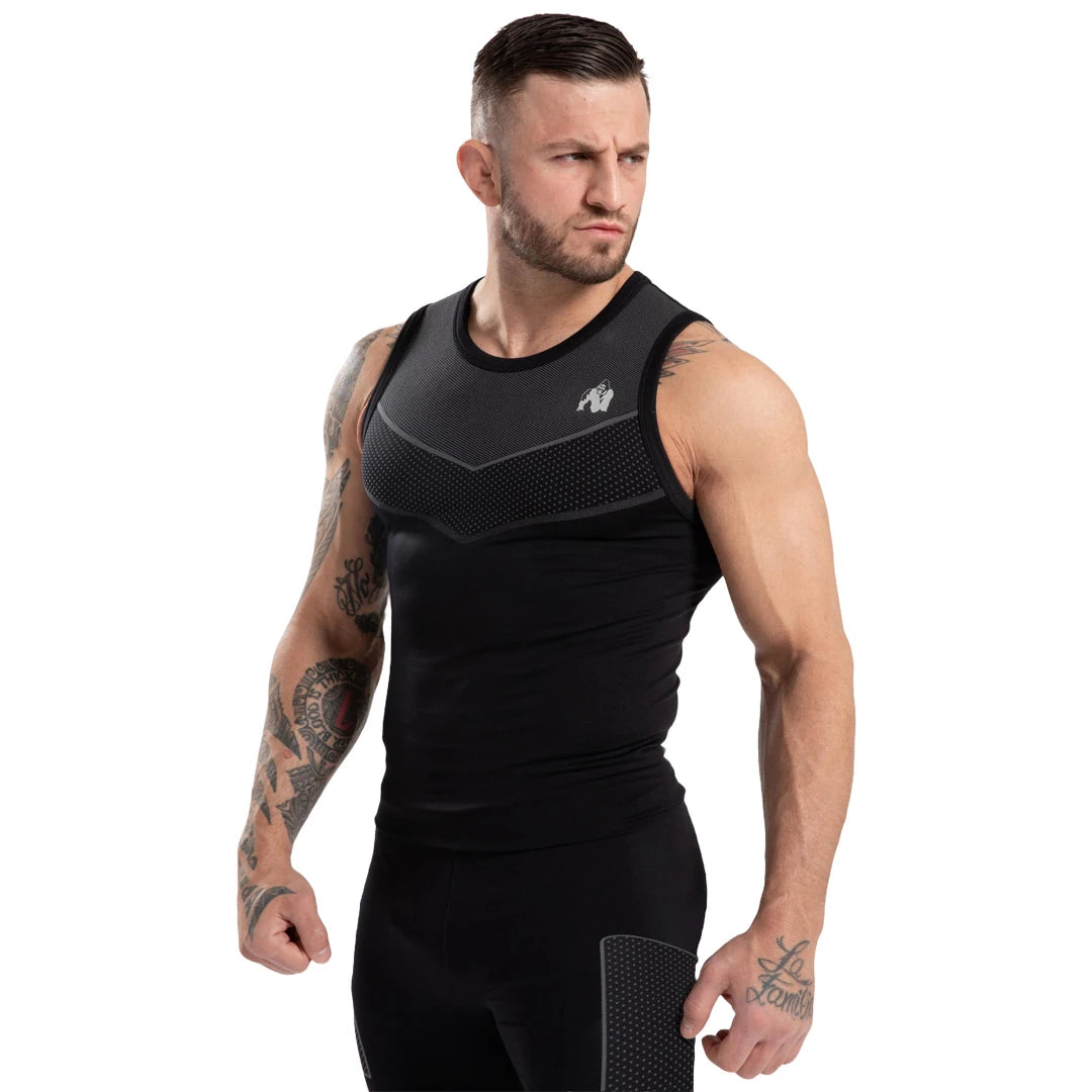 Man bär Gorilla Wear Norton Seamless Tank Top Black, ett sömlöst träningslinne med grå mönstrade detaljer., bild 5 av 6