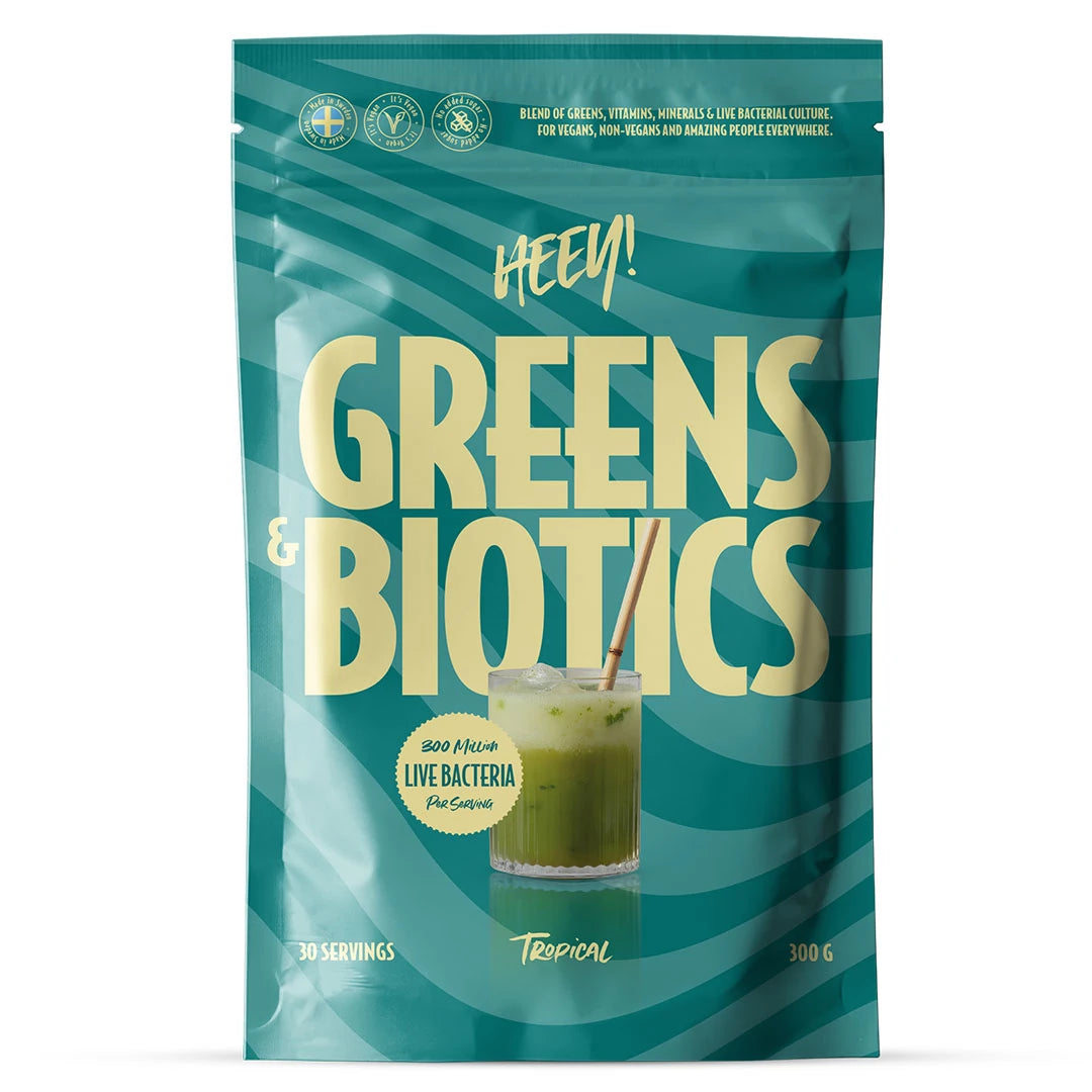 Heey! Greens &amp; Biotics Superfood + Probiotics 300 g i en blågrön påse för smaken Tropical., bild 1 av 3