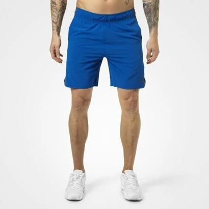 Better Bodies Brooklyn Shorts Strong Blue, blå träningsshorts för herr i vävd polyester på en manlig modell., bild 1 av 2