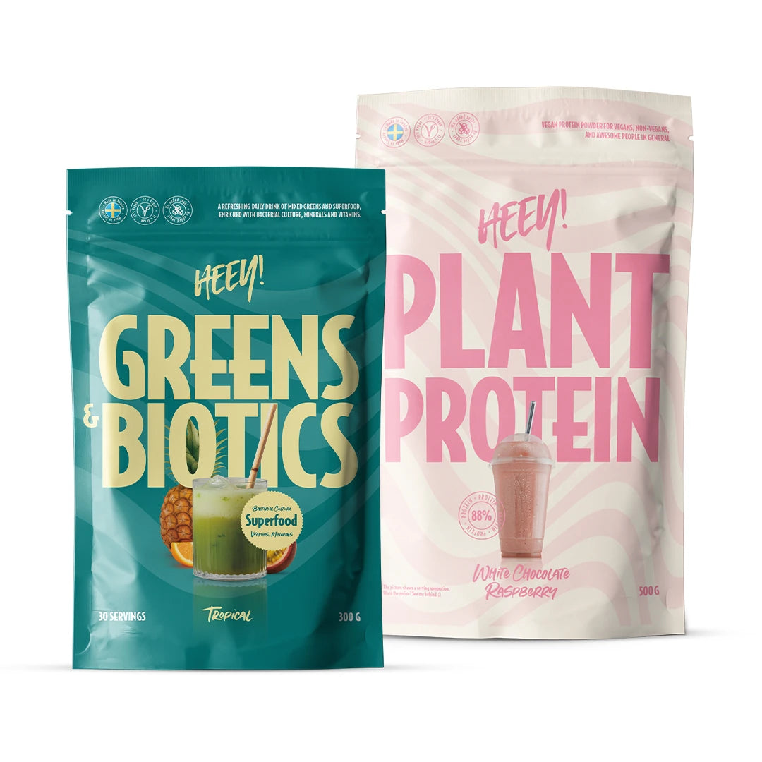 Heey! Wellness paket med en turkos påse Greens & Biotics och en rosa påse Plant Protein.